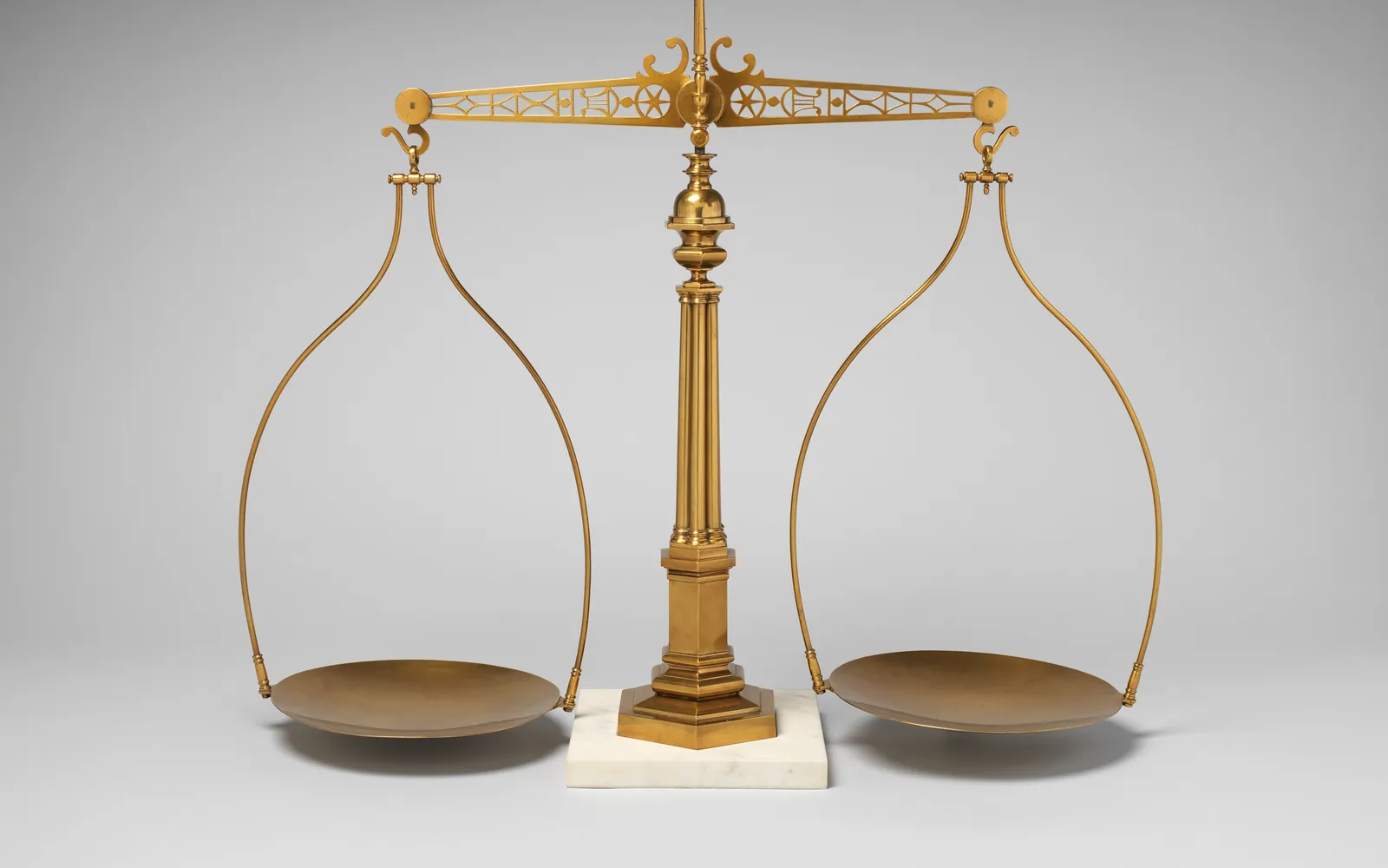 A brass balance scale with two pans